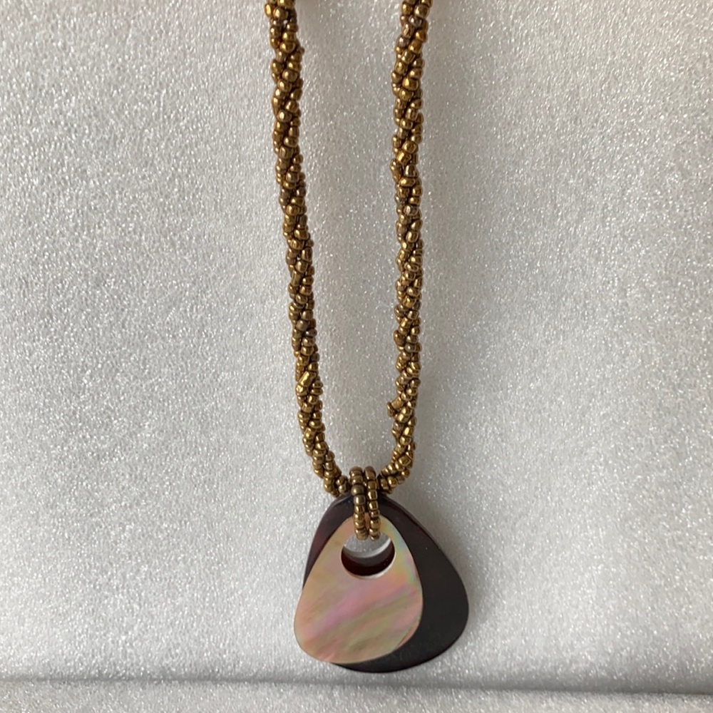 Opalescent, acrylic pendant on a beaded gold cord type of chain.  Holiday pick🎁
